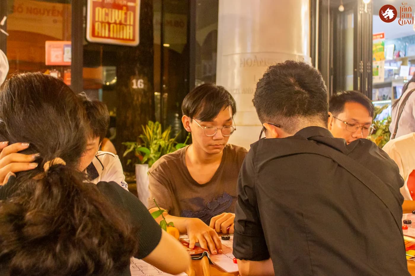 Hình ảnh khách tham dự trải nghiệm Cờ Thủy Tinh châu tại Ngày Hội Sách & Văn hóa Đêm lần 6 với chủ đề "Cầm Kỳ Thư Họa" được tổ chức ở Đường Sách Nguyễn Văn Bình.